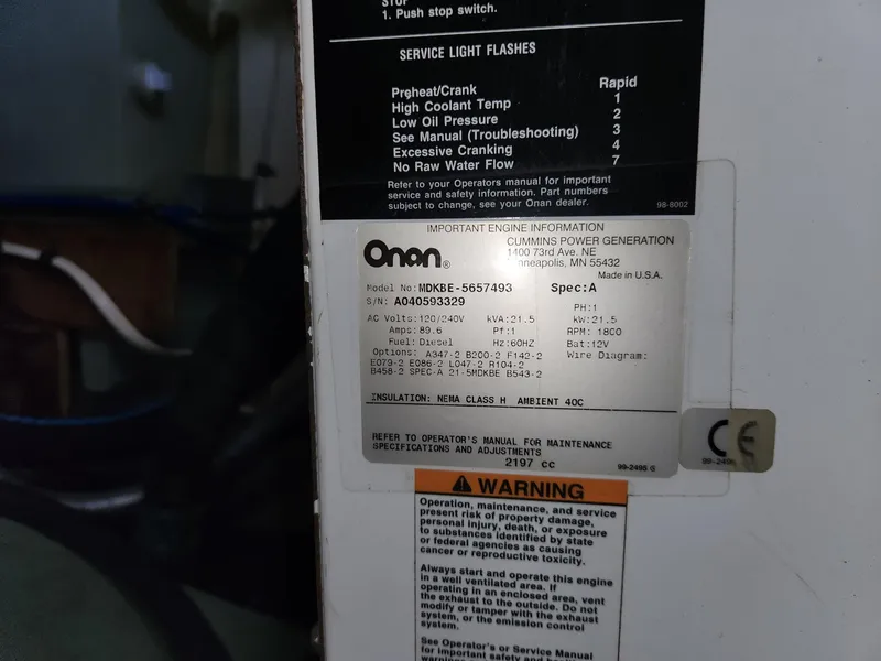 Slide: The Image of ```json
{
  "alt_text": "Onan engine information label on Tuna Rose Brothers 1980 model."
}
``` - 35