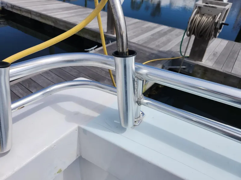 Slide: The Image of Chrome railing on a 1980 Tuna Rose Brothers boat docked at a marina. - 37