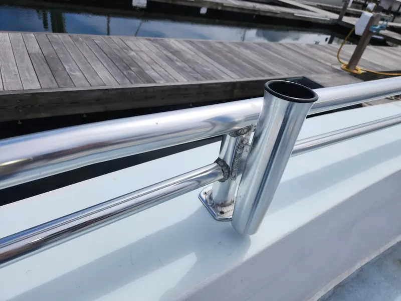 Slide: The Image of Stainless steel rod holder on a 1980 Tuna Rose Brothers boat at a marina. - 38