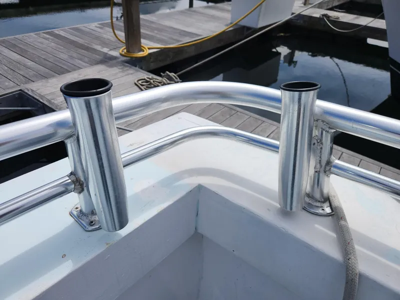 Slide: The Image of Stainless steel rod holders on a 1980 Tuna Rose Brothers boat at a dock. - 39
