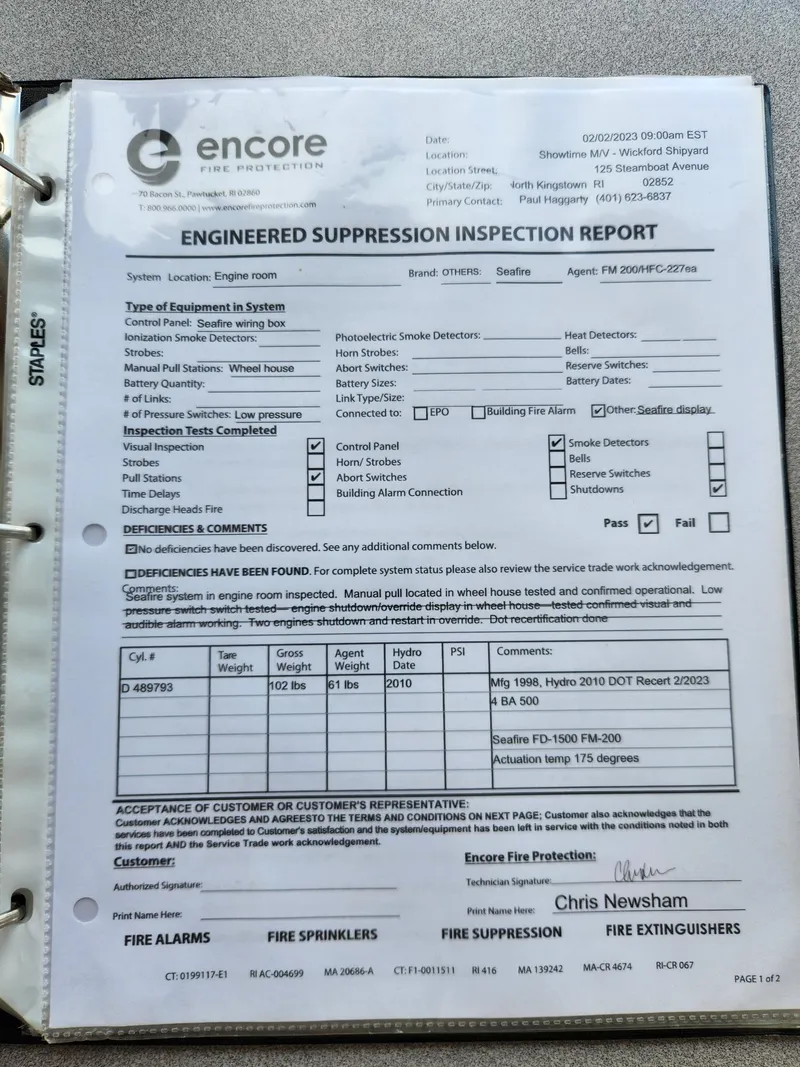 Slide: The Image of Engineered suppression inspection report in binder, featuring detailed system checks and signatures. - 40