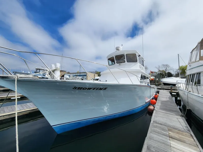 Slide: The Image of 1980 Tuna Rose Brothers boat docked at marina under blue sky. - 5