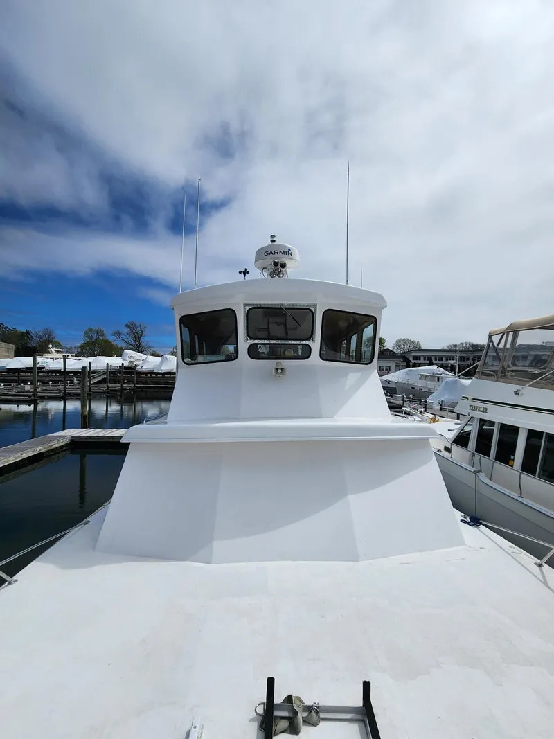 Slide: The Image of 1980 Tuna Rose Brothers boat docked under cloudy sky. - 7