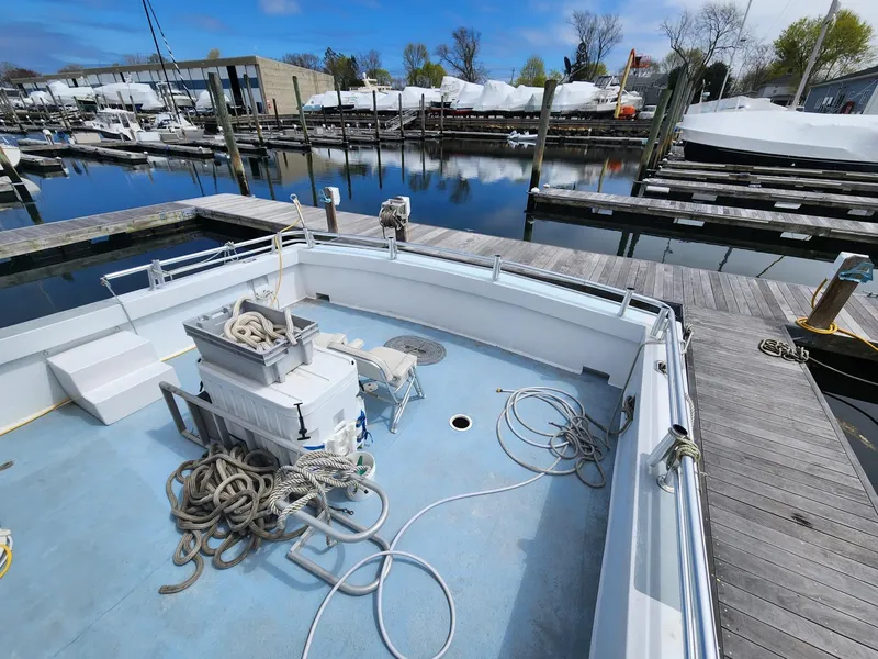 Slide: The Image of 1980 Tuna Rose Brothers boat docked, featuring ropes and equipment on deck. - 8