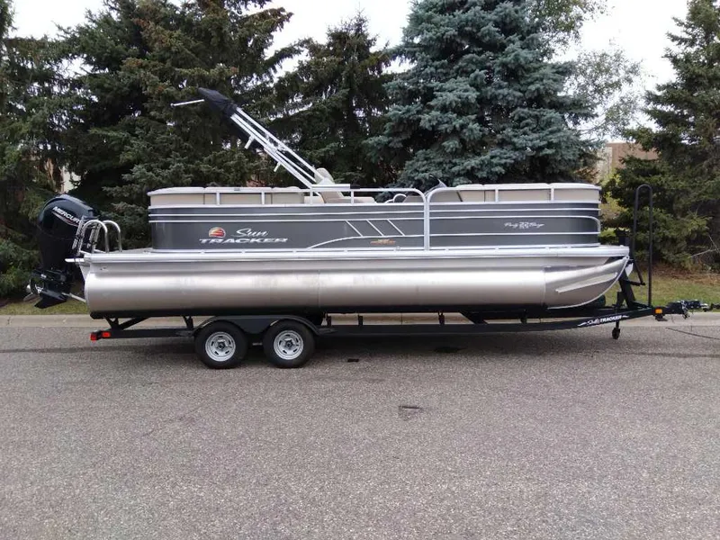 The Image of 2023 Sun Tracker Party Barge 22 RF DLX pontoon boat on trailer, parked on road. - 0
