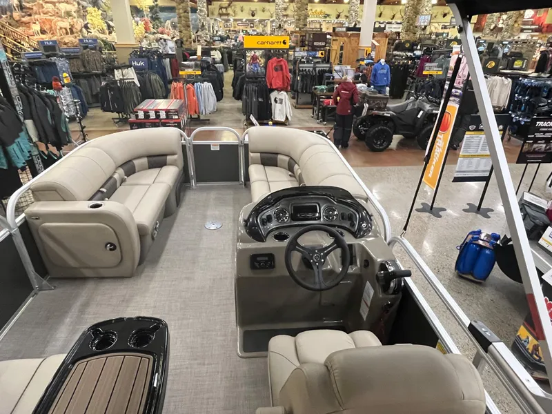 Slide: The Image of 2023 Sun Tracker Party Barge 22 RF DLX pontoon boat interior at a showroom. - 3