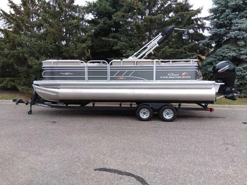 Slide: The Image of 2023 Sun Tracker Party Barge 22 RF DLX pontoon boat on trailer, parked outdoors. - 8