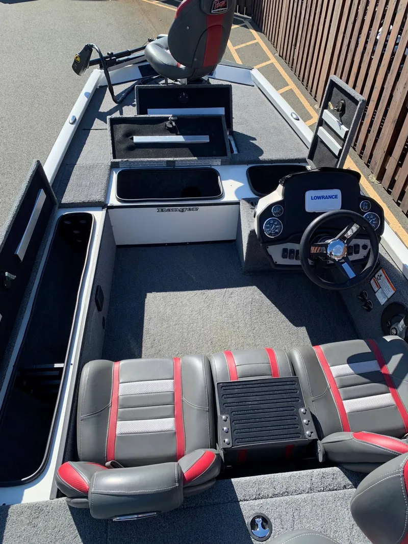 Slide: The Image of 2021 Ranger RT188C fishing boat interior with seats, steering wheel, and storage compartments. - 6