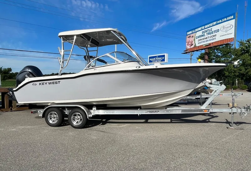 Slide: The Image of 2024 Key West 239 DFS boat on a trailer under a clear blue sky. - 0