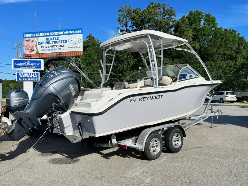 Slide: The Image of 2024 Key West 239 DFS boat on a trailer with Yamaha outboard motor. - 1