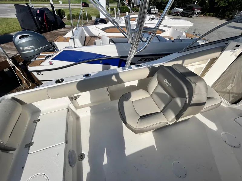 Slide: The Image of 2024 Key West 239 DFS boat interior with seating and Yamaha outboard motor. - 11