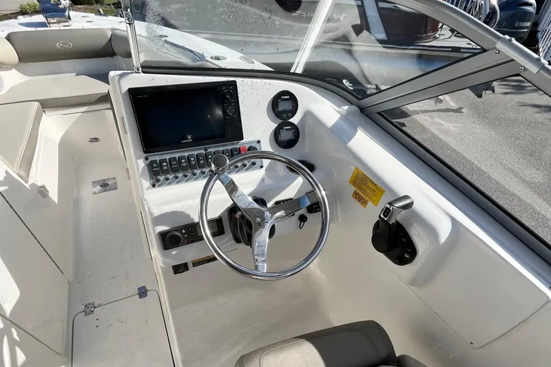Slide: The Image of 2024 Key West 239 DFS boat cockpit with steering wheel and control panel. - 6