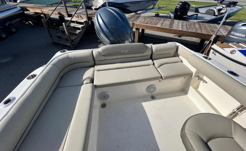 Slide: The Image of 2024 Key West 239 DFS boat interior with cushioned seating and outboard motor. - 8