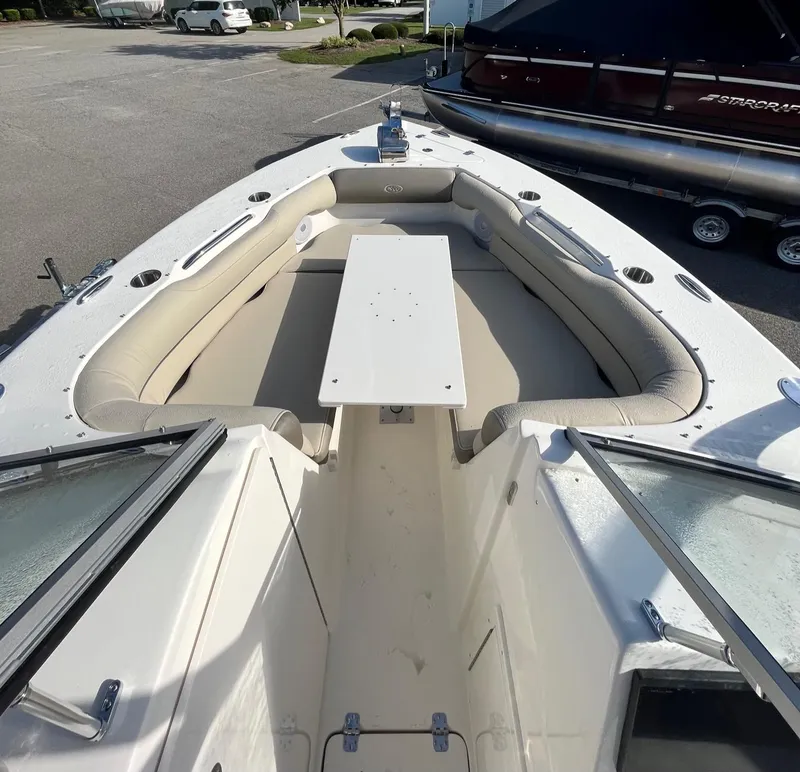 Slide: The Image of 2024 Key West 239 DFS boat interior with cushioned seating and table. - 11