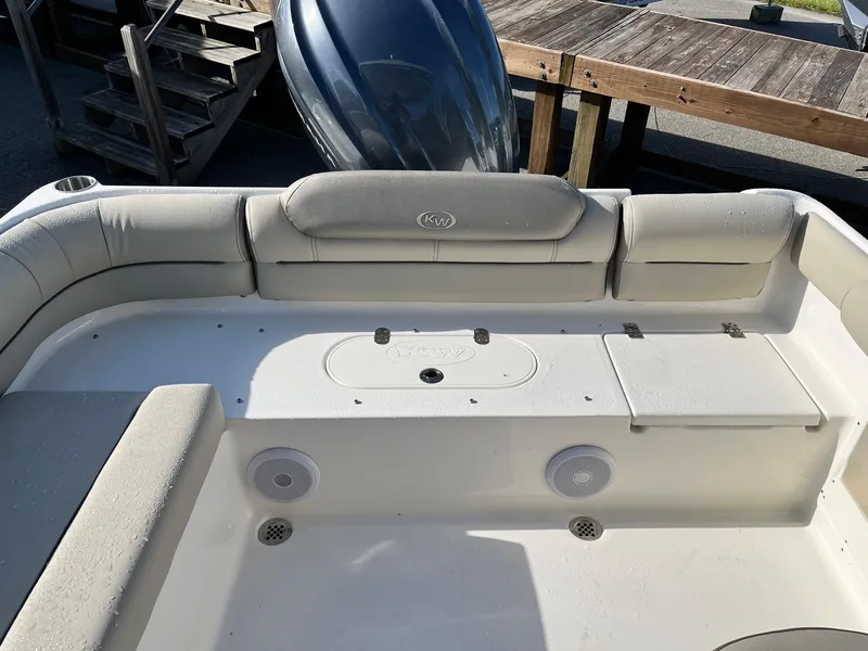 Slide: The Image of 2024 Key West 239 DFS boat interior with cushioned seating and storage compartments. - 15