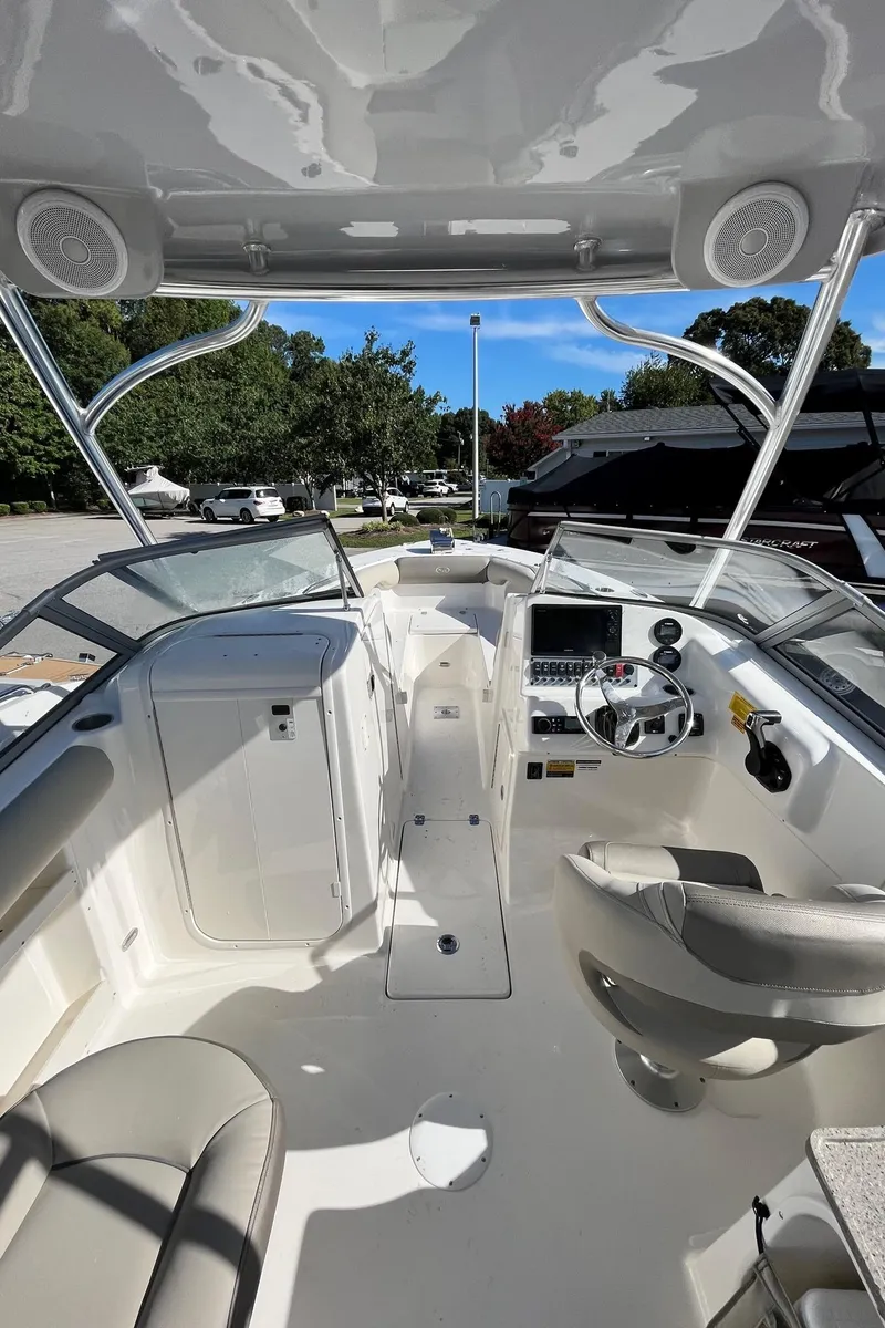 Slide: The Image of 2024 Key West 239 DFS boat interior with helm, seating, and dashboard. - 17