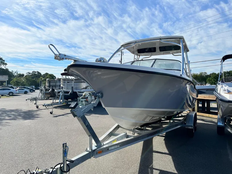 Slide: The Image of 2024 Key West 239 DFS boat on trailer under blue sky. - 3