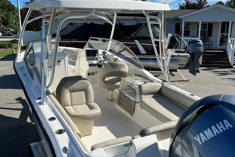 Slide: The Image of 2024 Key West 239 DFS boat with Yamaha engine, beige seating, and modern dashboard. - 4