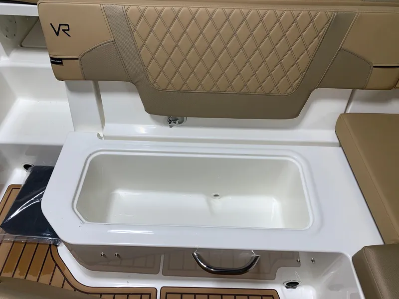 Slide: The Image of 2024 Bayliner VR5 boat storage compartment with cushioned seating. - 5