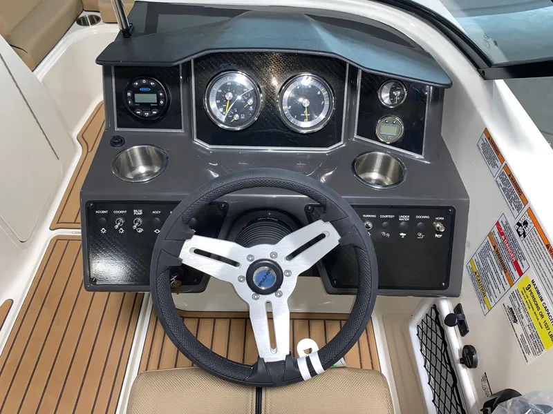 Slide: The Image of 2024 Bayliner VR5 boat dashboard with steering wheel and instrument panel. - 7