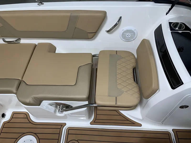 Slide: The Image of 2024 Bayliner VR5 boat interior with tan seating and teak flooring. - 9
