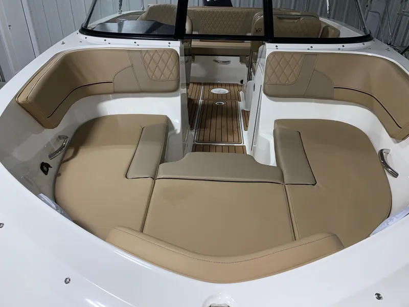 Slide: The Image of 2024 Bayliner VR5 boat interior with tan leather seating and wood flooring. - 14