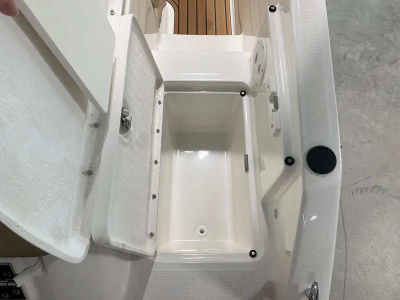 Slide: The Image of 2024 Bayliner VR5 boat storage compartment with open lid, showcasing spacious interior. - 15