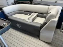 Slide: The Image of 2023 Sweetwater 2286SB boat interior with cushioned seating and cup holders. - 11