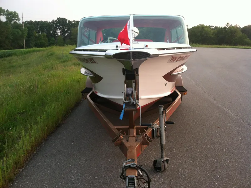 Slide: The Image of 1959 Century Coronado boat on trailer, parked on roadside with grassy background. - 8