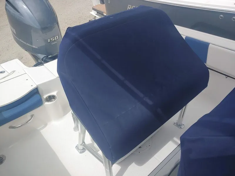Slide: The Image of 2022 Robalo R180 Center Console boat with blue seat cover and Yamaha 150 engine. - 10