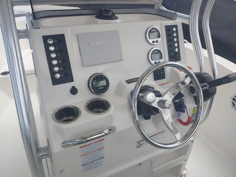 Slide: The Image of 2022 Robalo R180 Center Console dashboard with steering wheel and control panel. - 13