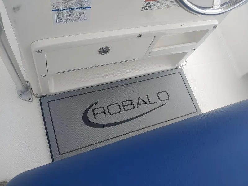 Slide: The Image of 2022 Robalo R180 Center Console interior with branded mat and storage compartment. - 14