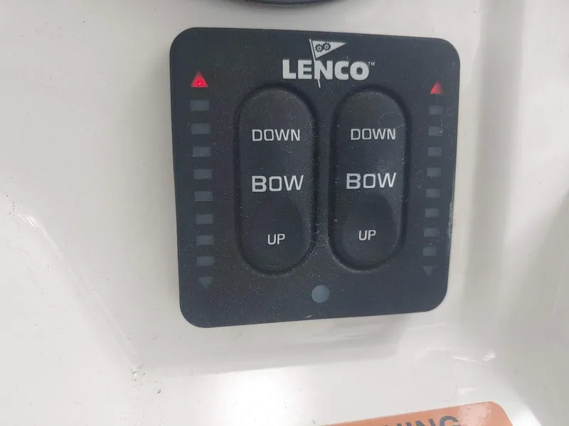 Slide: The Image of Lenco trim tab control panel on 2022 Robalo R180 Center Console boat. - 18