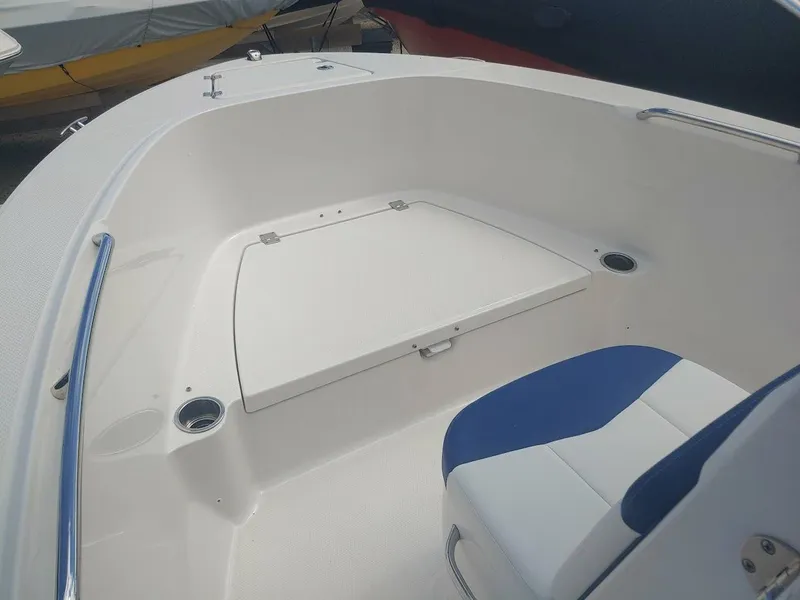 Slide: The Image of 2022 Robalo R180 Center Console boat interior with seating and storage. - 19