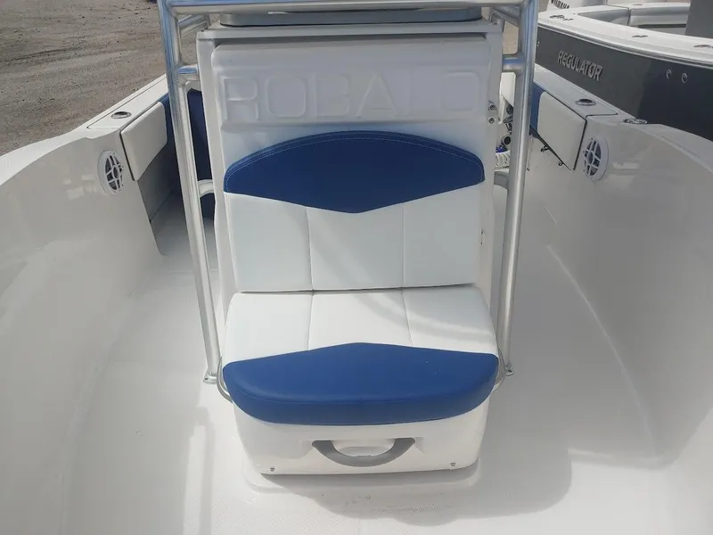 Slide: The Image of 2022 Robalo R180 Center Console boat seat with blue and white cushions. - 22