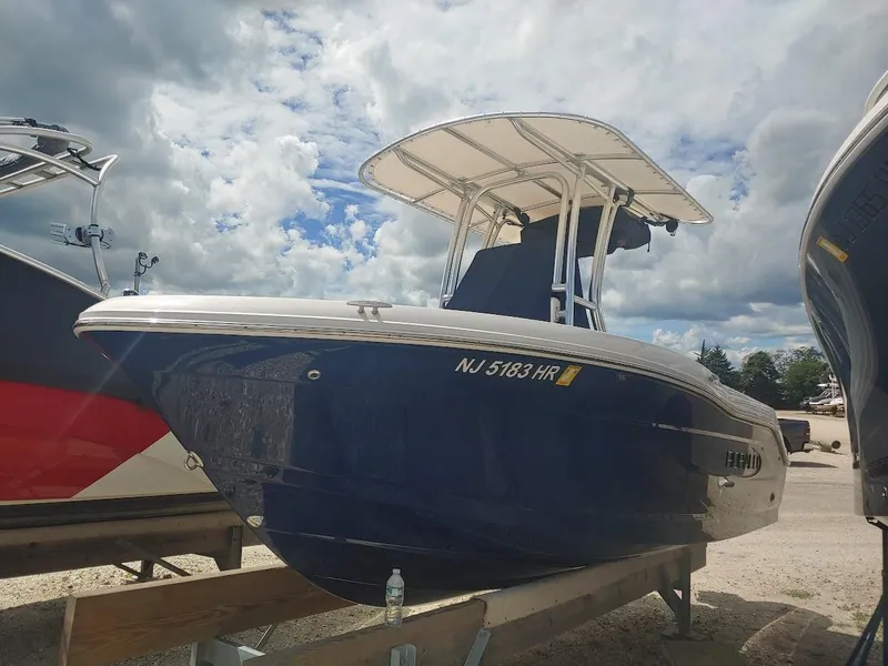 Slide: The Image of 2022 Robalo R180 Center Console boat on trailer under cloudy sky. - 3