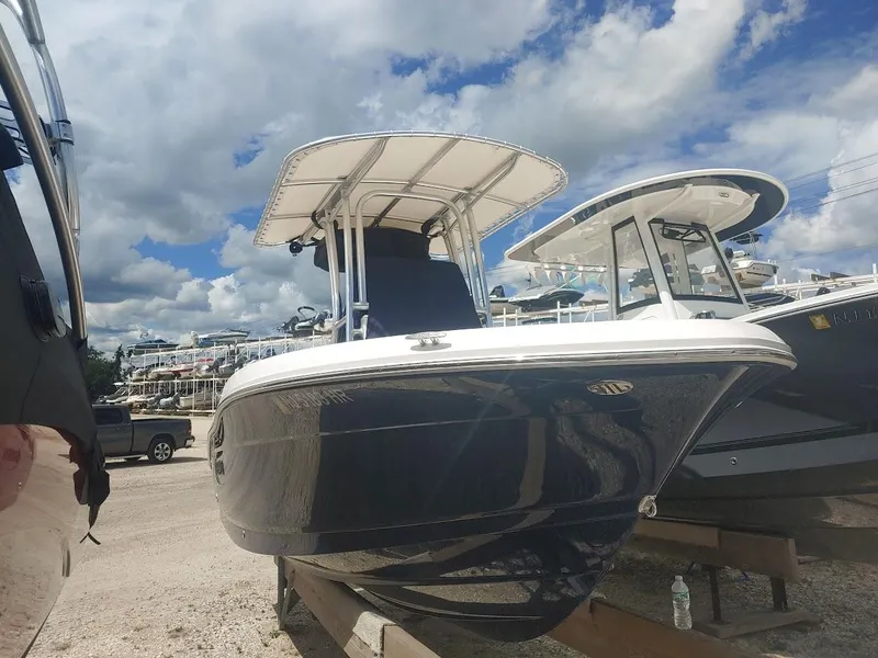 Slide: The Image of 2022 Robalo R180 Center Console boat displayed outdoors under a cloudy sky. - 4