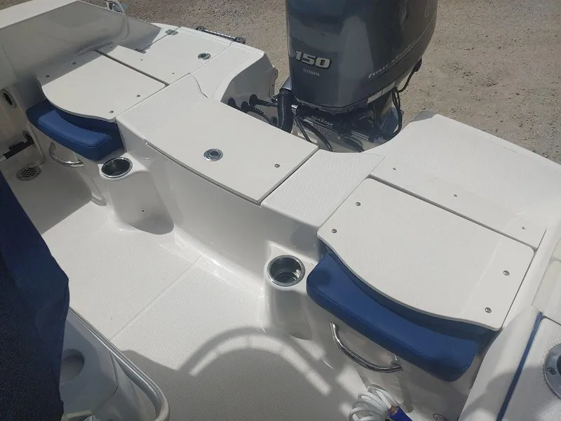 Slide: The Image of 2022 Robalo R180 Center Console boat interior with seating and motor. - 7