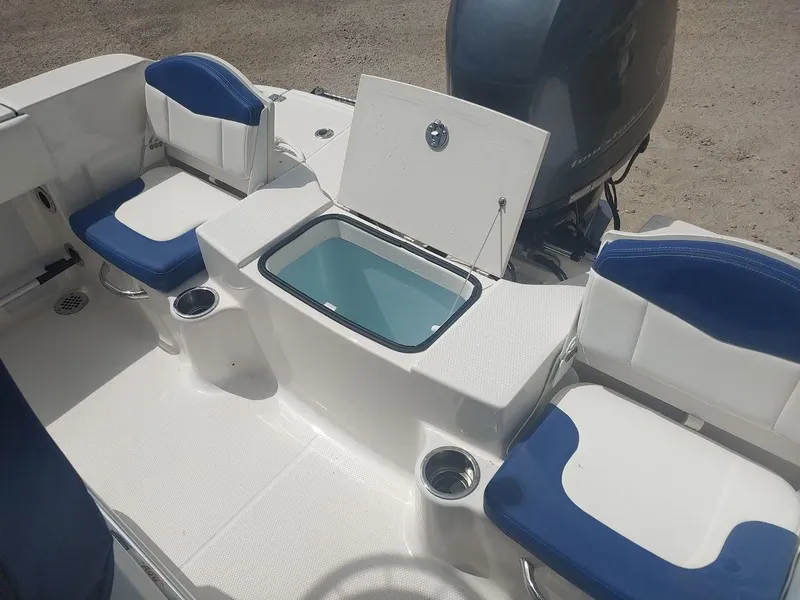 Slide: The Image of 2022 Robalo R180 Center Console boat interior with seating and storage compartments. - 8