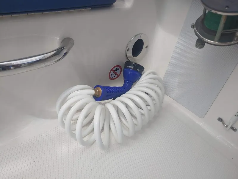 Slide: The Image of Coiled hose in 2022 Robalo R180 Center Console boat interior. - 9