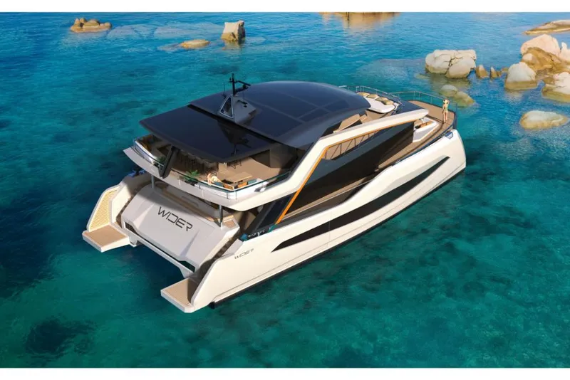 Slide: The Image of Luxury Wider 92 yacht 2023 model cruising in clear blue waters. - 1