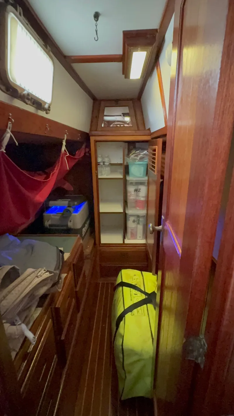 Slide: The Image of 1984 Shannon Aegean 51 yacht interior with wooden cabinetry, storage shelves, and nautical decor. - 12