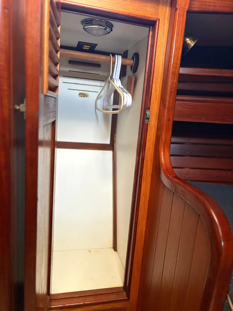 Slide: The Image of Wooden closet interior on 1984 Shannon Aegean 51 yacht with hangers. - 19