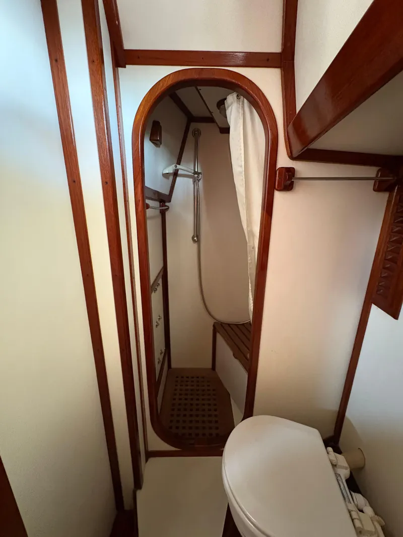 Slide: The Image of 1984 Shannon Aegean 51 yacht bathroom with wooden accents and compact shower. - 22