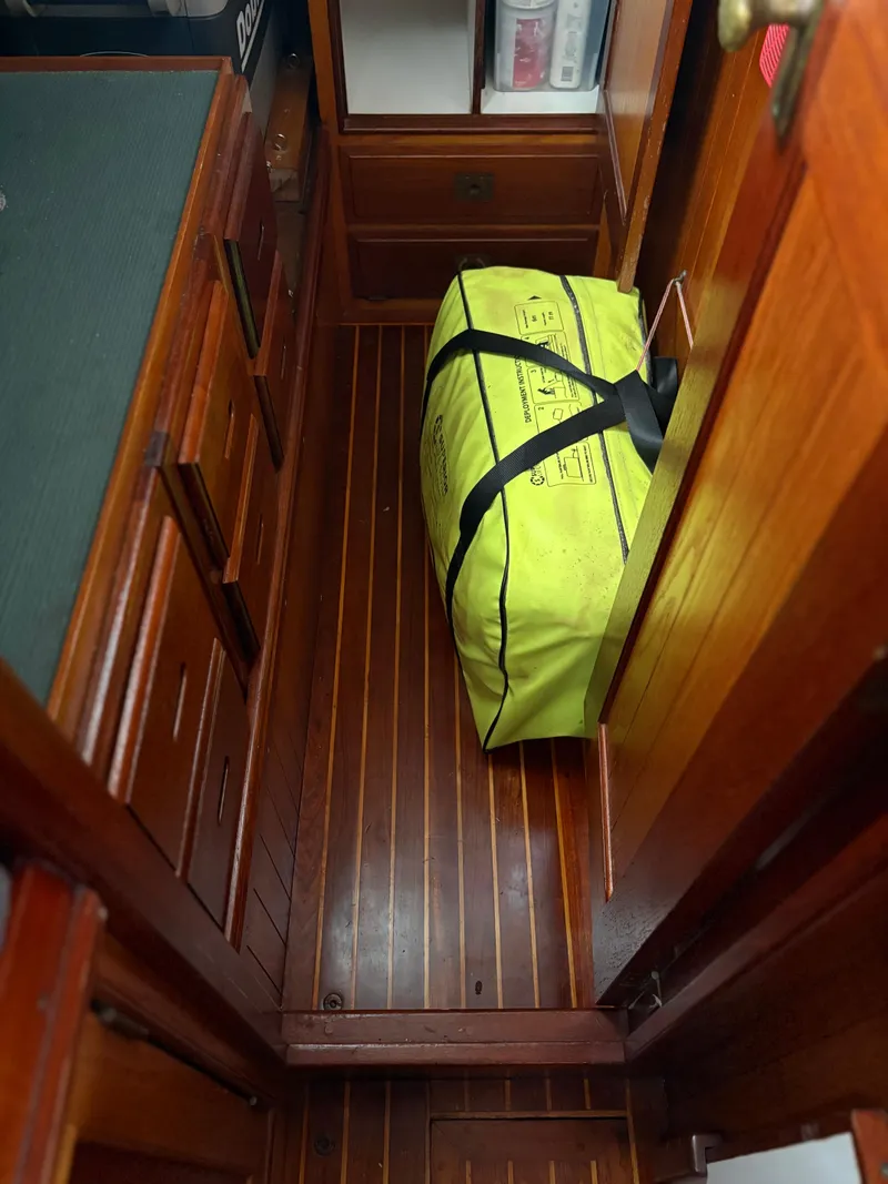 Slide: The Image of Wooden interior of 1984 Shannon Aegean 51 with yellow bag on floor. - 23