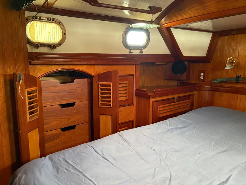 Slide: The Image of 1984 Shannon Aegean 51 yacht cabin with wooden interior and porthole windows. - 24