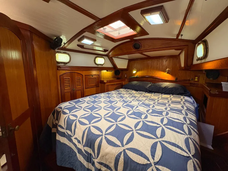 Slide: The Image of Luxurious cabin interior of 1984 Shannon Aegean 51 yacht with elegant wood finish and cozy bedding. - 25