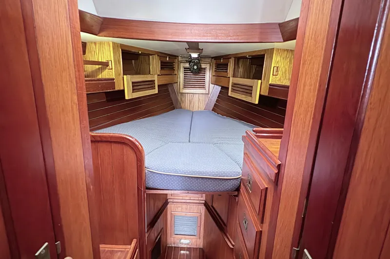 Slide: The Image of Interior of 1984 Shannon Aegean 51 sailboat with wooden finish and cozy sleeping area. - 3