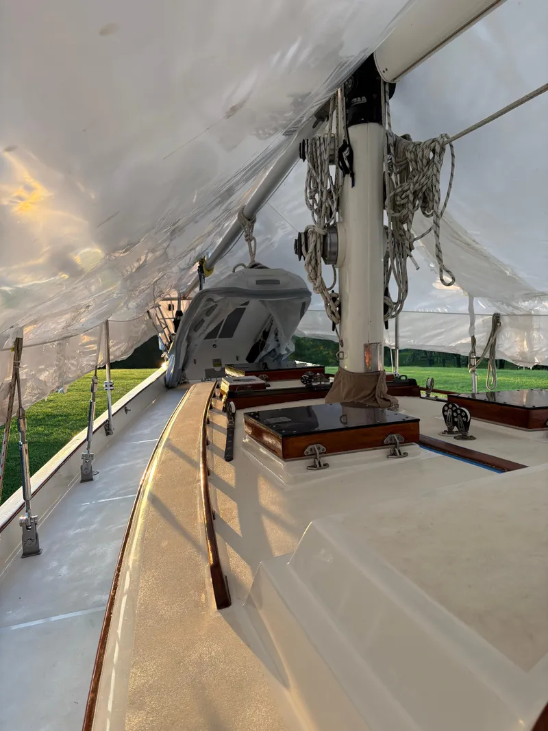 Slide: The Image of 1984 Shannon Aegean 51 sailboat under protective cover, showcasing deck and rigging. - 34