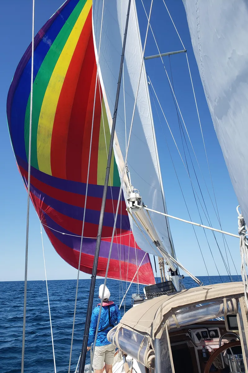 Slide: The Image of Sailing on 1984 Shannon Aegean 51 with colorful spinnaker and clear blue sky. - 35